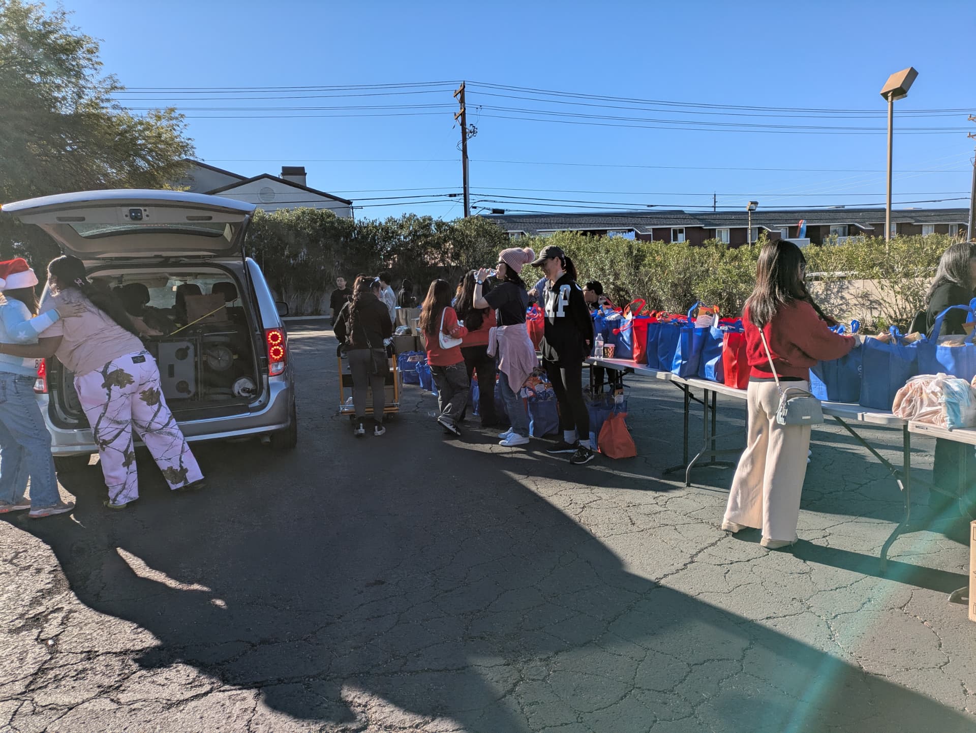 Volunteers loading groceries into a vehicle at the holiday distribution