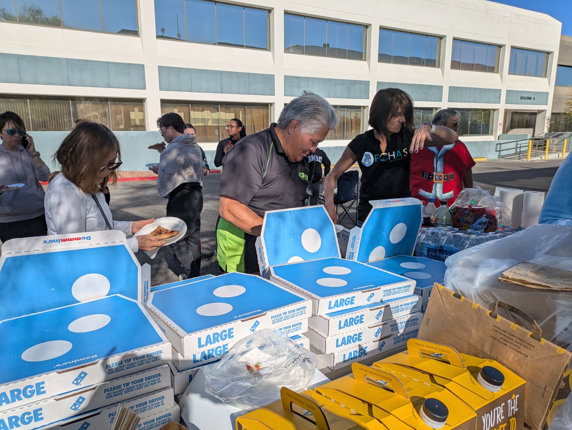Volunteers gathered around donated pizza and coffee at the holiday event